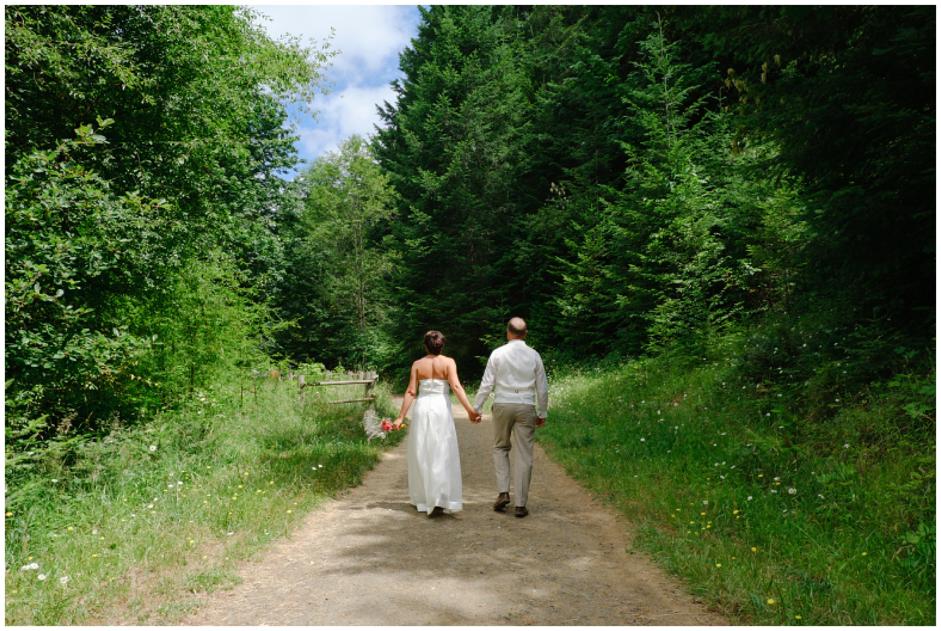 Bride and groom walking along trail