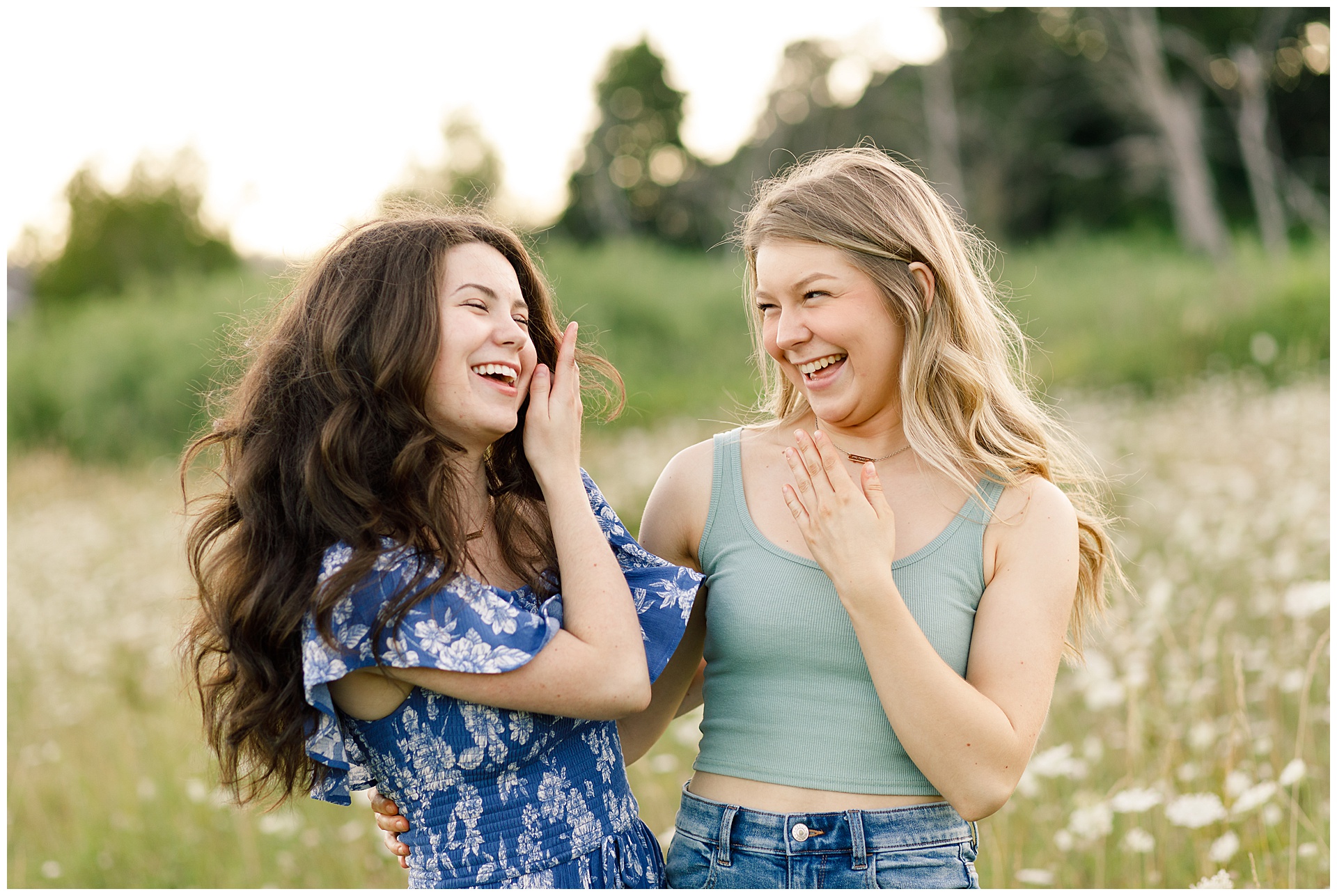 sisters laughing during senior portraits outdoors in Corvallis Oregon
